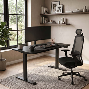 Modern home office with a black desk, chair, and computer setup.