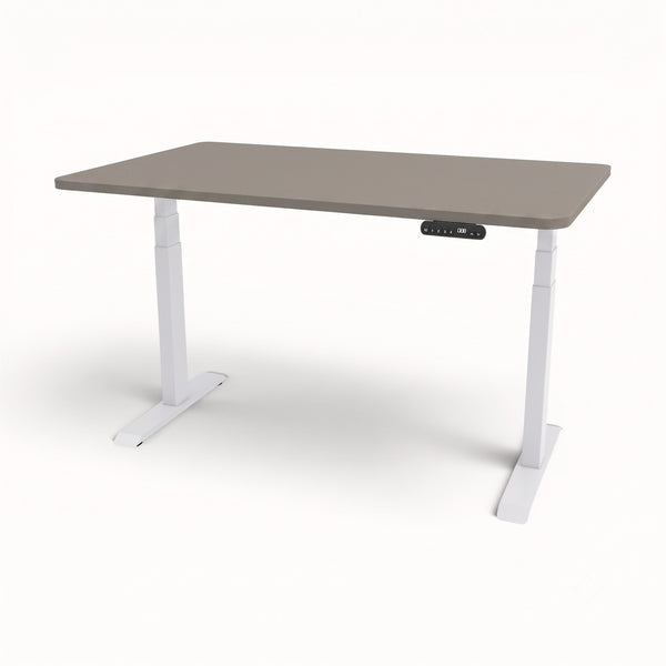 An adjustable standing desk with a taupe-gray rectangular top and white T-style legs, featuring a small black control panel on the front right side.